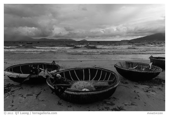 Coracle boats on beach during storm. Da Nang, Vietnam (black and white)