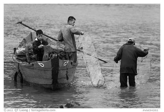 Men operating fish traps. Vietnam