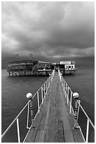 Boarwal, offshore restaurant, and threatening clouds. Vietnam (black and white)