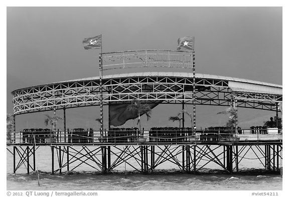 Communist flags flying on restaurant. Vietnam (black and white)