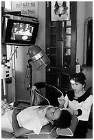 Man getting ear cleaning. Vietnam ( black and white)