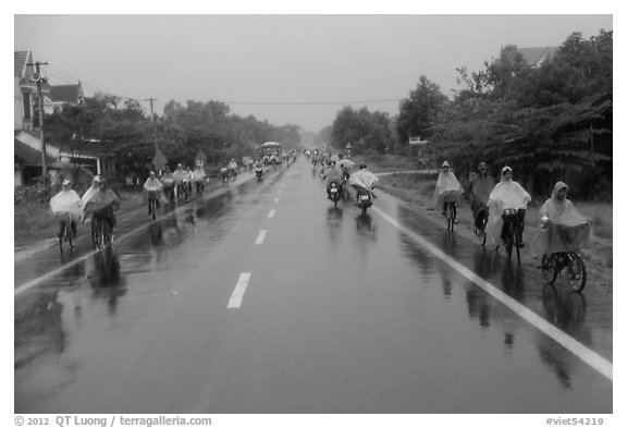 Riders wearing colorful ponchos on wet road on Hwy 1 south of Hue. Vietnam