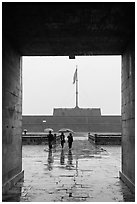 Tourists with unbrellas and flag monument, citadel. Hue, Vietnam (black and white)