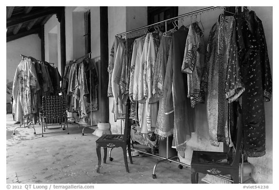 Coat hangers with silk robes in imperial style, citadel. Hue, Vietnam (black and white)