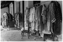 Coat hangers with silk robes in imperial style, citadel. Hue, Vietnam (black and white)