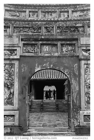 Palace and silhouettes seen from doorway, citadel. Hue, Vietnam (black and white)