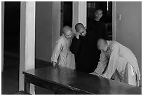Monks looking at book, Thien Mu pagoda. Hue, Vietnam (black and white)