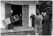 Monks carrying furniture, Thien Mu pagoda. Hue, Vietnam (black and white)