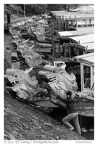 Woman pushes dragon boat. Hue, Vietnam (black and white)