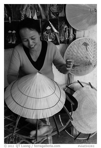 Woman crafting conical hat. Hue, Vietnam (black and white)