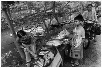 Boy waiting for donut coooked near canal, Thanh Toan. Hue, Vietnam (black and white)