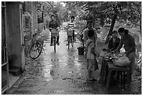 Canalside street with bicyclists and food stand, Thanh Toan. Hue, Vietnam (black and white)