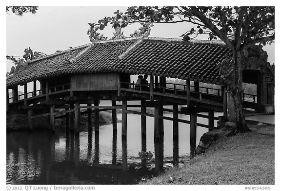 Friends sitting inside covered bridge, Thanh Toan. Hue, Vietnam (black and white)