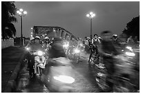 Night motorcyle traffic out of Trang Tien bridge. Hue, Vietnam (black and white)