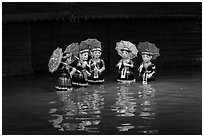 Water puppets (5 characters with umbrellas), Thang Long Theatre. Hanoi, Vietnam (black and white)