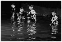 Water puppets (4 characters with musical instruments), Thang Long Theatre. Hanoi, Vietnam (black and white)