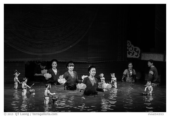 Puppeters coming from behind the bamboo screen after performance, Thang Long Theatre. Hanoi, Vietnam (black and white)