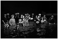 Water puppet artists standing in pool after performance, Thang Long Theatre. Hanoi, Vietnam (black and white)