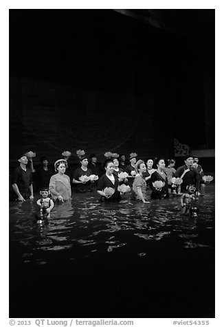 Water puppet artists receiving applause in pool after performance, Thang Long Theatre. Hanoi, Vietnam (black and white)