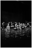 Water puppet artists receiving applause in pool after performance, Thang Long Theatre. Hanoi, Vietnam (black and white)