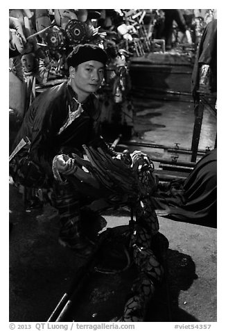 Water puppet artist holding dragon backstage, Thang Long Theatre. Hanoi, Vietnam (black and white)