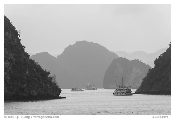 Tour boats and islands in mist. Halong Bay, Vietnam (black and white)