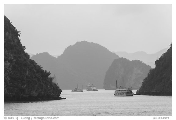 Tour boats and islands in mist. Halong Bay, Vietnam