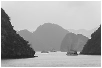 Tour boats and islands in mist. Halong Bay, Vietnam (black and white)