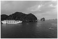 Tour boat and sea kayaks. Halong Bay, Vietnam (black and white)