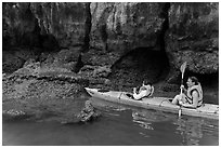 Sea kayakers approaching monkey. Halong Bay, Vietnam (black and white)