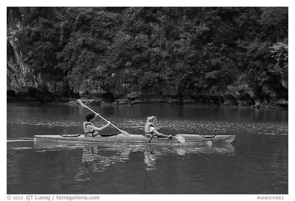 Sea kayakers on emerald waters. Halong Bay, Vietnam (black and white)