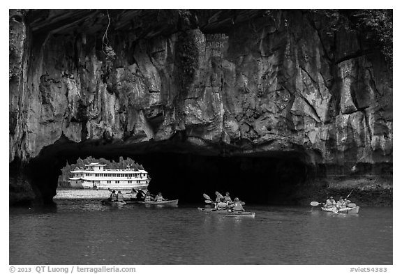 Kayaks floating through Luon Can tunnel. Halong Bay, Vietnam (black and white)