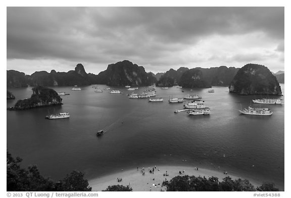 Crescent beach, boats and karst, Titov Island. Halong Bay, Vietnam (black and white)