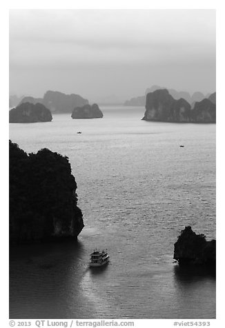 Tour boat navigating between islets. Halong Bay, Vietnam (black and white)