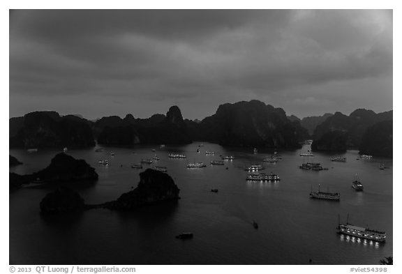 Tour boats lights and islands from above at night. Halong Bay, Vietnam