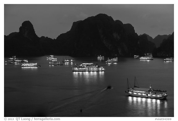 Flotilla of tour boats and islands at night. Halong Bay, Vietnam