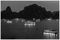 Flotilla of tour boats and islands at night. Halong Bay, Vietnam ( black and white)