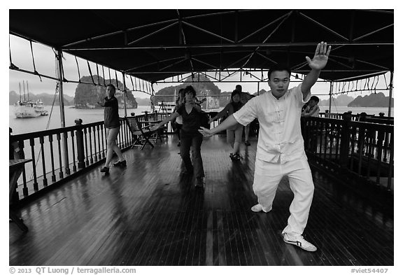 Morning Tai Chi session on tour boat deck. Halong Bay, Vietnam (black and white)