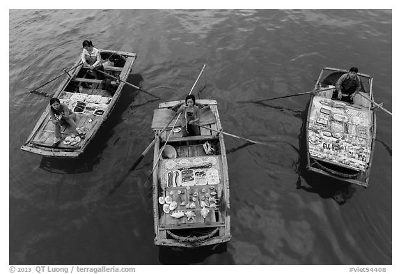 Women selling sea shells and perls from row boats. Halong Bay, Vietnam (black and white)