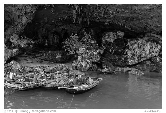 Fishermen anchor eating breakfast in cave. Halong Bay, Vietnam (black and white)