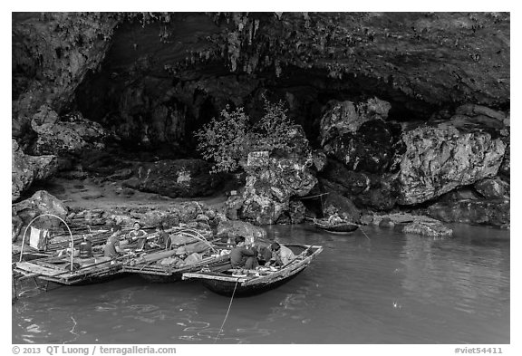 Fishermen anchor eating breakfast in cave. Halong Bay, Vietnam (black and white)