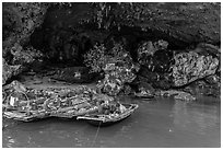 Fishermen anchor eating breakfast in cave. Halong Bay, Vietnam ( black and white)