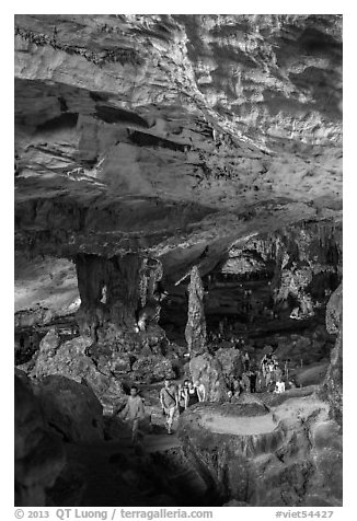 Visitors walking in cavernous chamber, Sungsot cave. Halong Bay, Vietnam