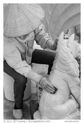 Woman polishing stone carving by hand. Vietnam (black and white)