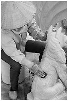 Woman polishing stone carving by hand. Vietnam (black and white)