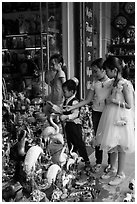 Children checkout ceramic store. Bat Trang, Vietnam (black and white)