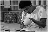 Man assembling ceramic tea pot in workshop. Bat Trang, Vietnam ( black and white)