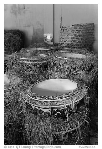 Ceramic vases wrapped in hay in storeroom. Bat Trang, Vietnam (black and white)