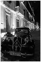 Vintage car in front of Metropole hotel at night. Hanoi, Vietnam (black and white)