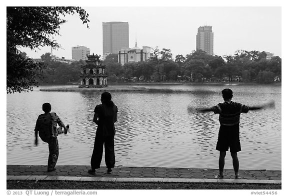 People exercising in front of Turtle Tower, Hoang Kiem Lake. Hanoi, Vietnam (black and white)
